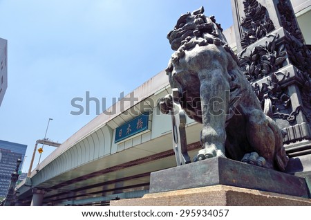Tokyo, Japan - JULY 10, 2015: A photo of a Bronze lion sculpture in the Nihonbashi Bridge newel. Lion sculpture has represented the guardian of Tokyo.