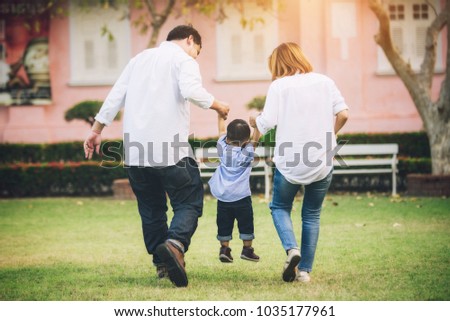 Happy Asian Family Walking and Hold Hands with Son in the Park - Lifestyle Concept
