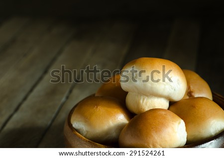 Still Life Warming Tone Dark Light Style of Mushroom Tuna Bread Recipe in Wooden Bowl on Old Wood Table - Texture Background
