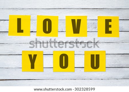 White Wood Planks with Text LOVE YOU on Yellow Post It for Texture Background