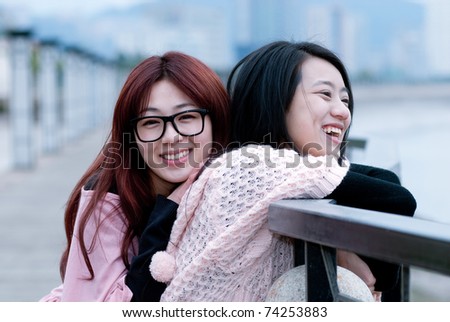 two girlfriends having fun outside
