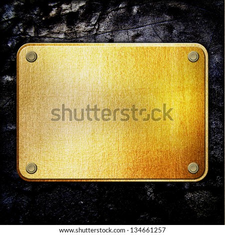 golden metal plate on concrete wall