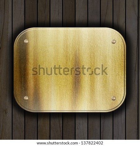 golden metal plate on wooden wall