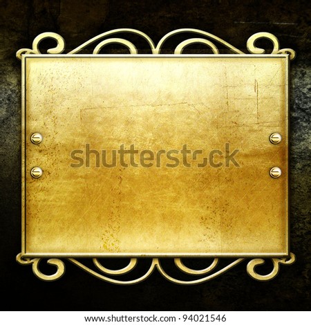 golden metal plate on concrete wall