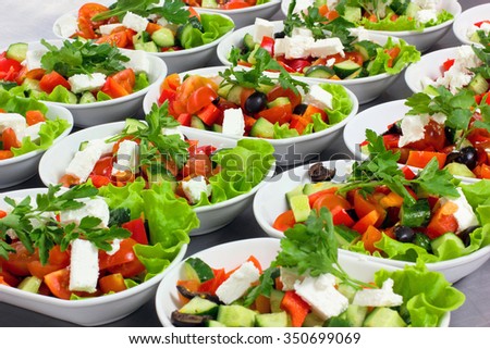 Greek salad with fresh vegetables, feta cheese and black olives, flight catering, aircraft, food on airplanes, many dishes with a Greek salad.