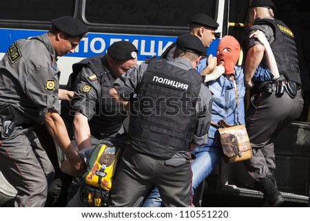 MOSCOW , RUSSIA - AUGUST 17. Pussy Riot protester  wears balaclava arrested by police  outside court.  People  protest  and support  members of Pussy Riot feminist punk band on August 17, 2012, Moscow