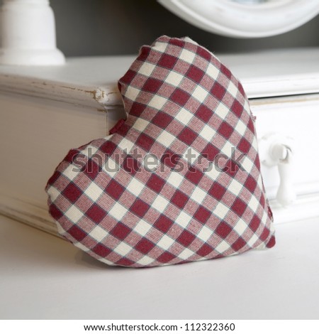 check red and white heart on bureau