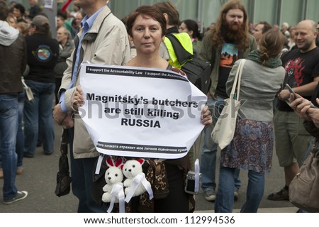 MOSCOW RUSSIA - SEPT 15. Tens of thousands oppositionists marched through Moscow in protest against President Putin  Woman holding poster in support Magnitsky`s list on September 15, 2012, Moscow