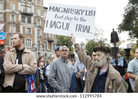 MOSCOW , RUSSIA - SEPT 15. Tens of thousands oppositionist  marched through Moscow in protest against President Putin . Man hold poster in support Magnitsky list. on September 15, 2012, Moscow