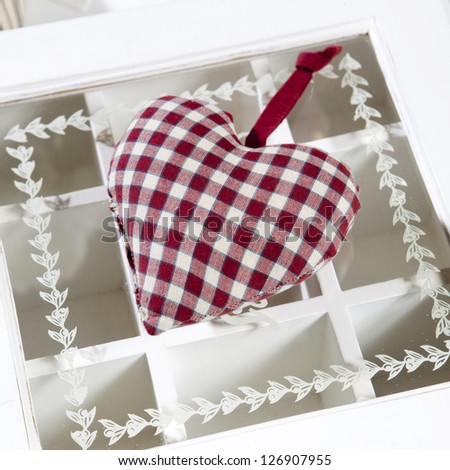 check red and white rag heart on bureau