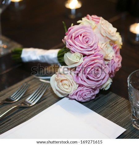 wedding bouquet of pink and white roses on the table