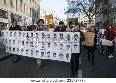 LONDON,ENGLAND- NOVEMBER 19: Students take part in protest  against fees in education on November 19, 2014 in London, England. Students carry poster with pictures of Mexican students murdered by Mafia