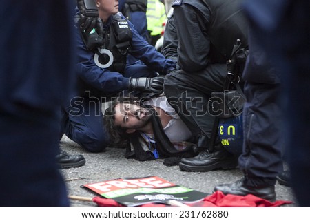 LONDON, ENGLAND - NOVEMBER 19: Students take part in a protest march against fees and cuts in the education system on November 19, 2014 in London, England. Police detains student