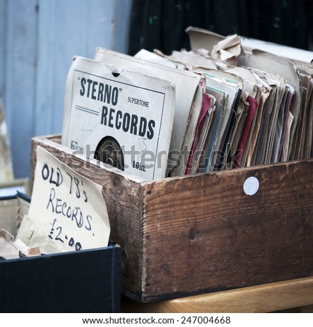 London - January 17, 2015. Flea market window shop with old-fashioned goods displayed in London city, UK, on 13 June 2014. Retro styled image of boxes with vinyl turntable records on a flee market