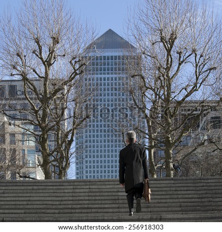 LONDON, UK - January 12 2015 - Mid Afternoon view of Canary Wharf London. People climb the stairs