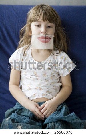 little cute upset  girl  with artificial lips sitting on sofa