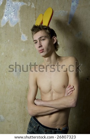 portrait of young cute thoughtful man with pirsing in eyebrow and rabbit`s ears