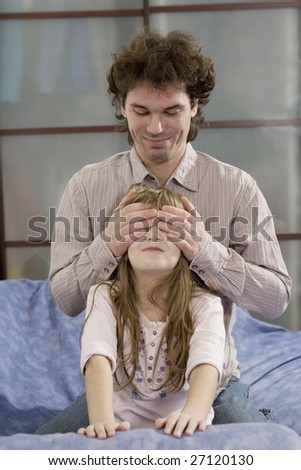 father and daughter. He closes eyes by hands