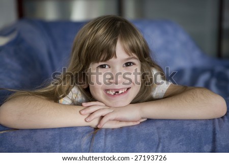 closeup portrait toothless cute smiling girl with long hair