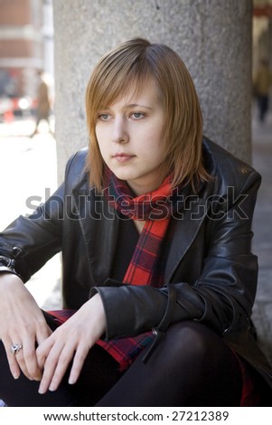 young attractive girl with red hair sitting on street, waiting. London. Covern Garden.