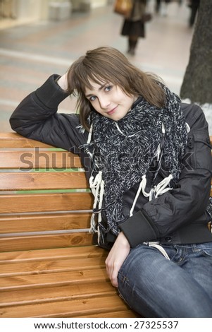 young attractive woman sitting on bench in state department store. Moscow
