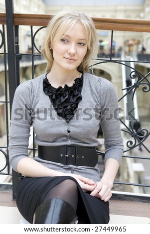 closeup portrait blond tired woman sitting on floor in store