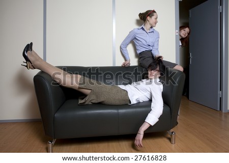 Tired boss lying on sofa. Secretary try to do  massage. Office people