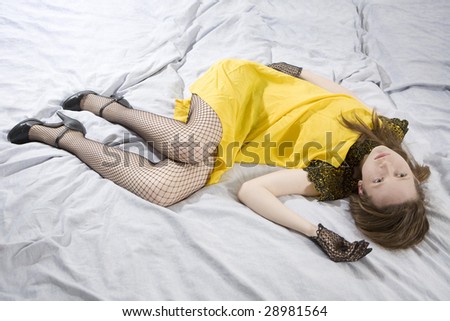 young cute woman in vintage yellow dress sleeping on bed