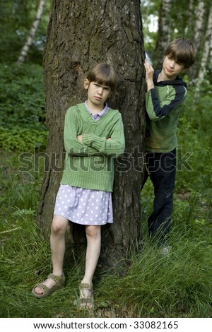 Hide-and-seek. Boy and girl playing  hide-and-seek