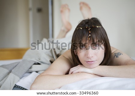 brunette pensive woman lying on bed