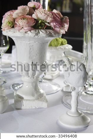 Bouquet of pink flower in vase of glass. Decoration of dining table. persian buttercup flowers (ranunculus) - wedding arrangement