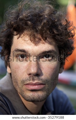 portrait of brunette serious man middle age  with freckles