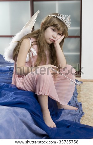 little cute girl eight years old wearing angel wings sad after festival