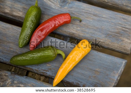 yellow, green, red  traffic light chili pepper  on blue old table