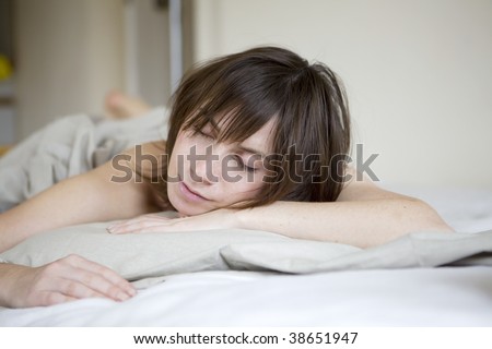 serious sad woman lying on bed 