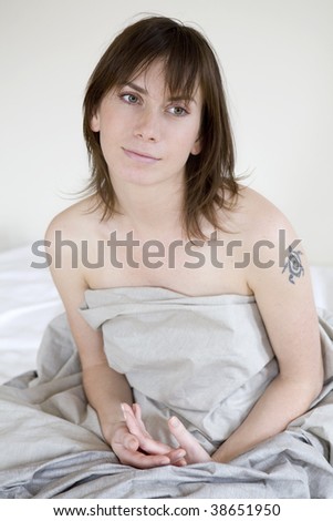 serious sad woman sitting on bed 