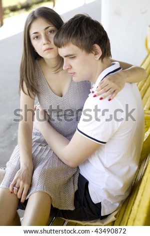 sad  teen couple sitting on a bench