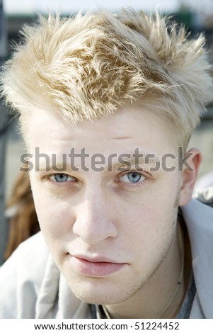 portrait of smiling young blond man
