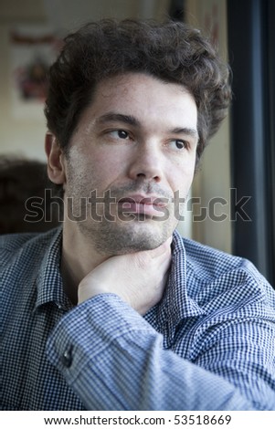 portrait young curl man looking at window in train