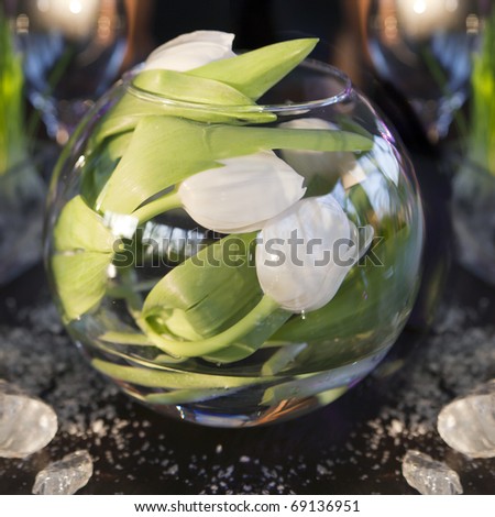 the dining table was decorated with the tulip  flower for the romantic time. Tulips  inside of vase
