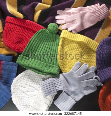 Colorful woolen scarf, hats and gloves background