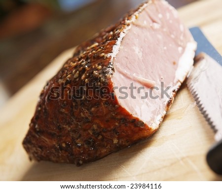 piece of meat and a knife on wood