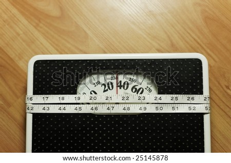 bathroom scale with a measure tape.focus on the tape