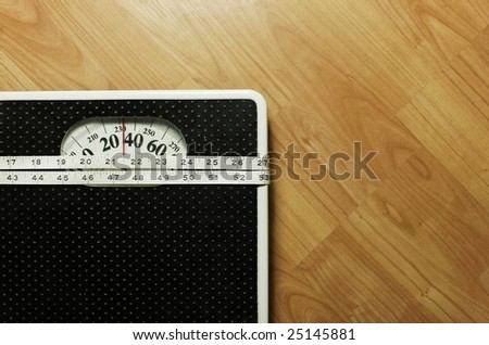 bathroom scale with a measure tape.focus on the tape