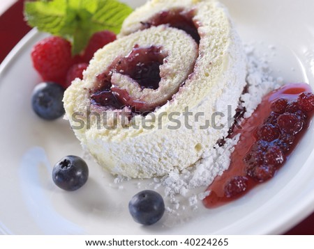 sweet swiss cake on a plate with fruit and jam. Shallow depth of field.
