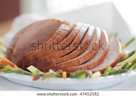 sliced baked ham on a plate with vegetable. Pork meat. Shallow depth of field.