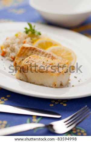 Fresh cooked cod fish with rice and lemon