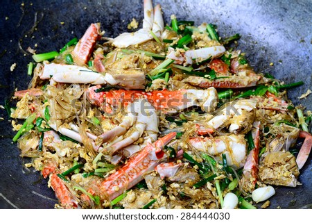 Thai Food (Boo Pad Pong Karee) : Sea Crab  stir fried  in Yellow Curry with Coconut Milk and cellophane noodle in pan