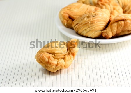 Curry puff  in white plate on bamboo pad plate