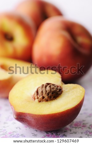 Peach cut in half with focus on peach pit.